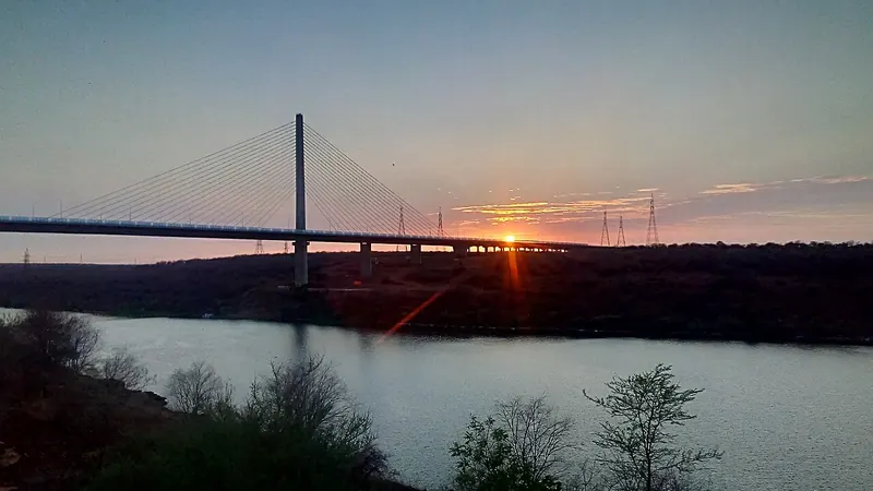 Kota hanging bridge silhouetted against the sunset over the Chambal